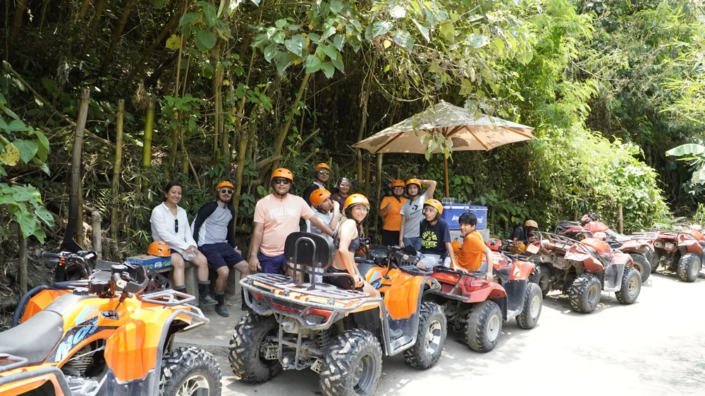 ATV convoy staging line resting under jungle canopy