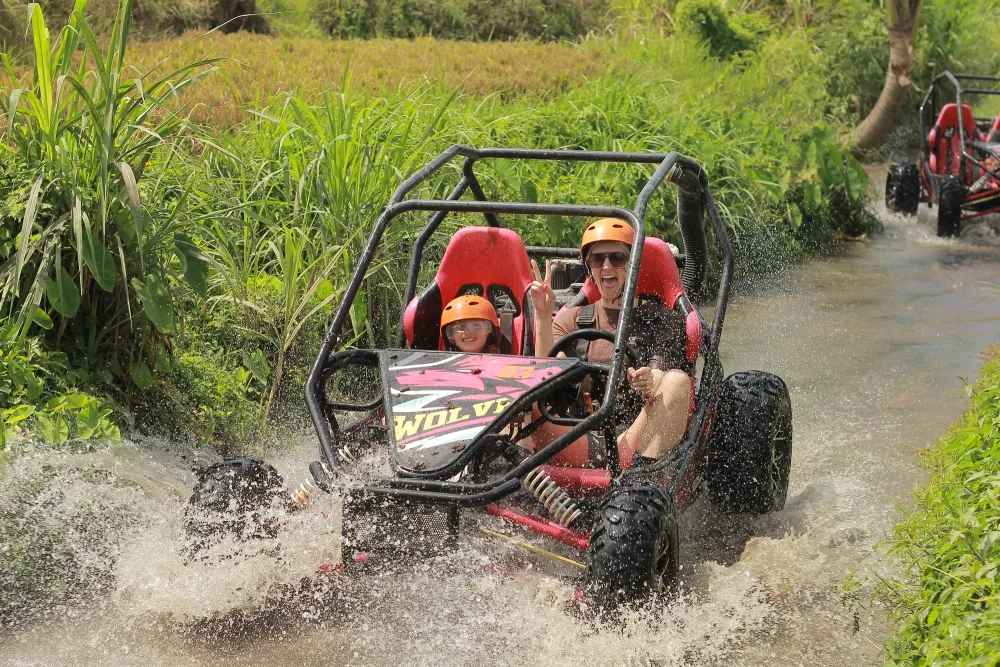 Buggy splashing through a tropical water crossing
